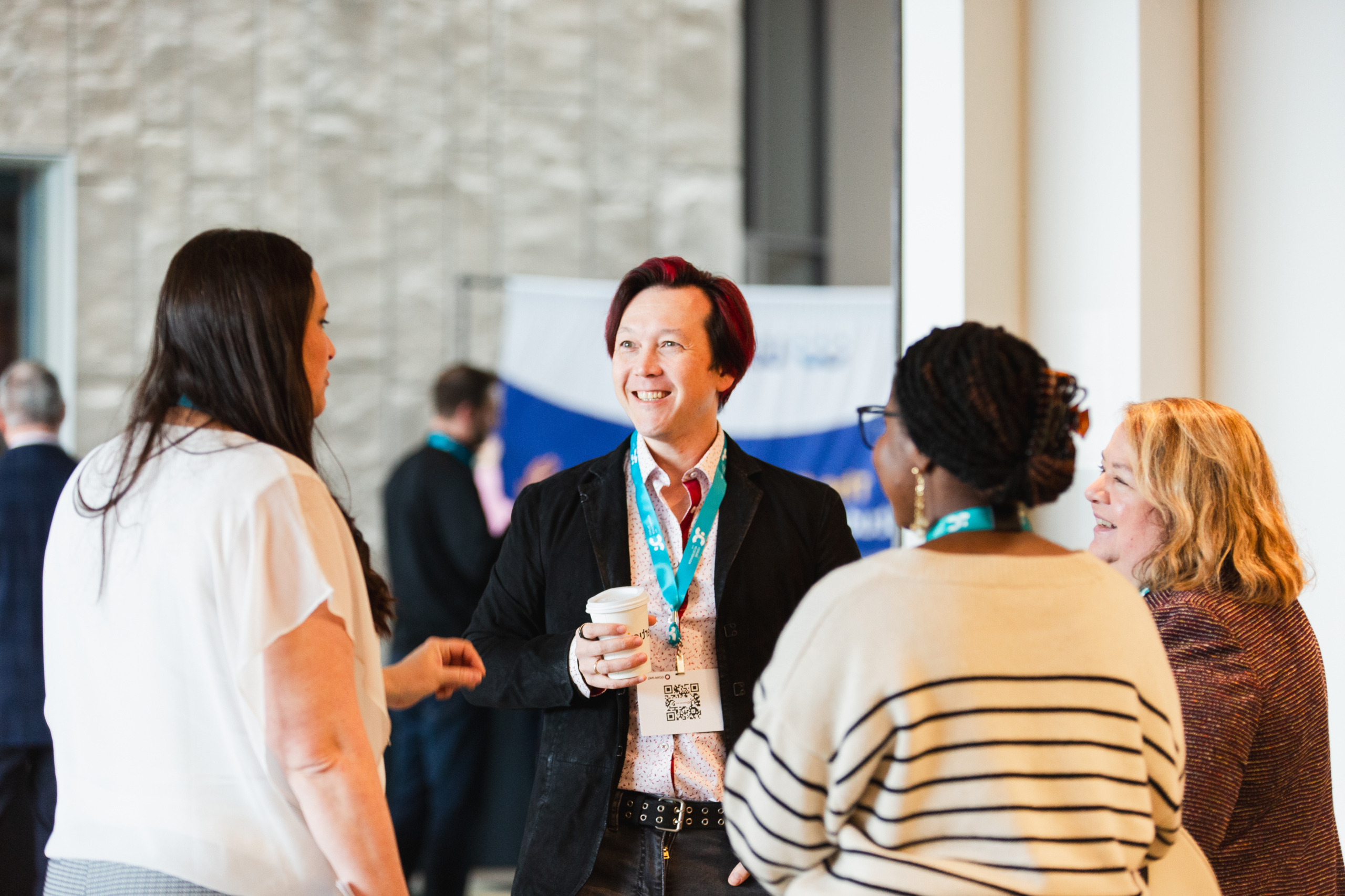 A diverse group of entrepreneurs talking at an event.