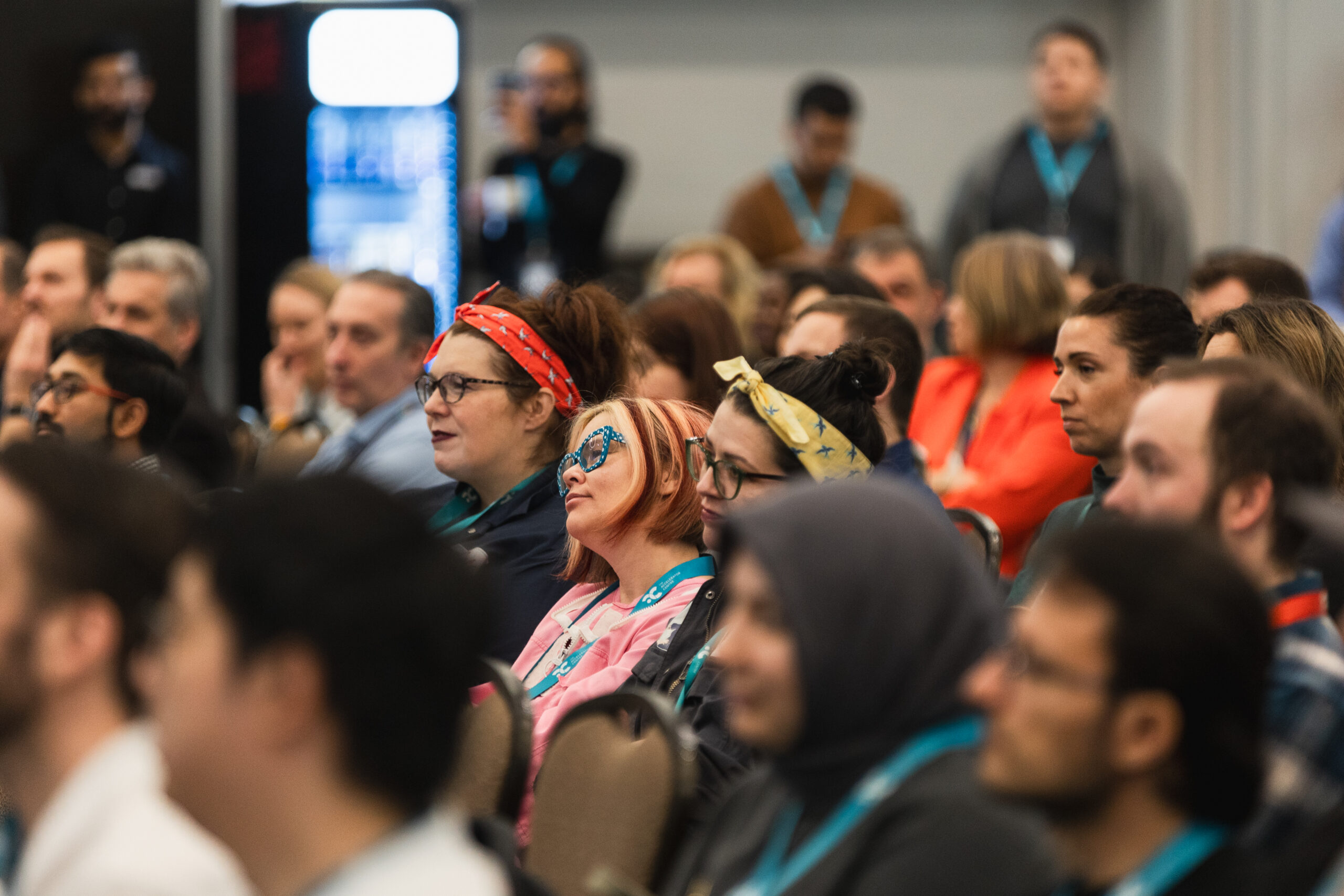 Audience members listening to a speech.