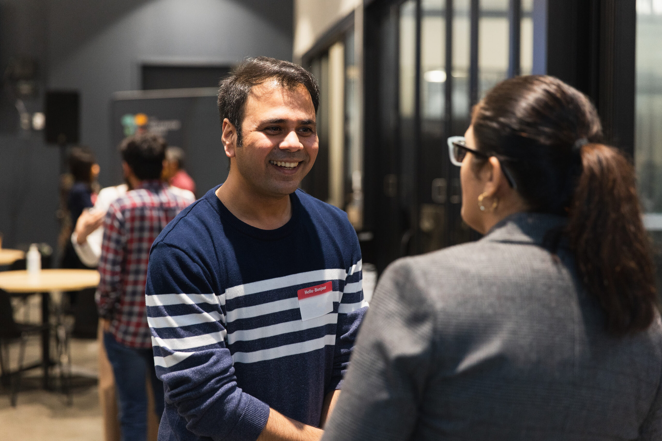 Partners and community members talking at an event.