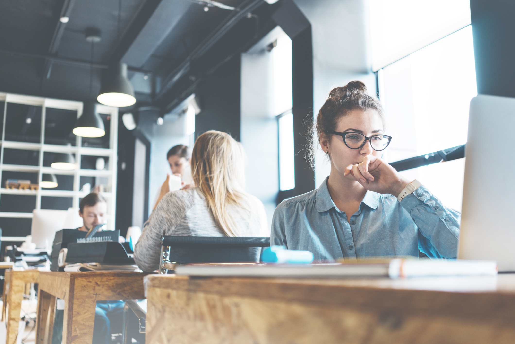 A person writing at a cafe.